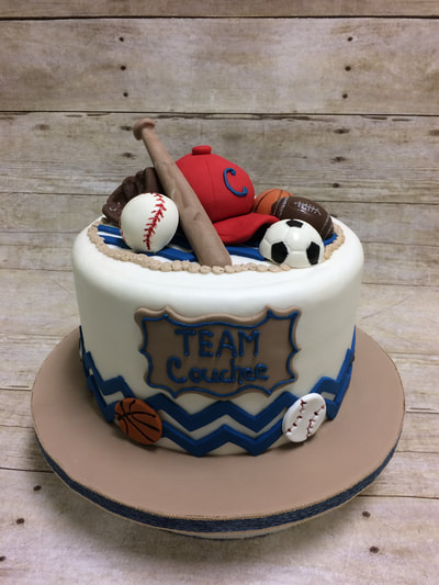 Baby shower cake boy. Sports themed baby shower cake for a boy with baseball, soccer, basketball even a baseball bat and hat.