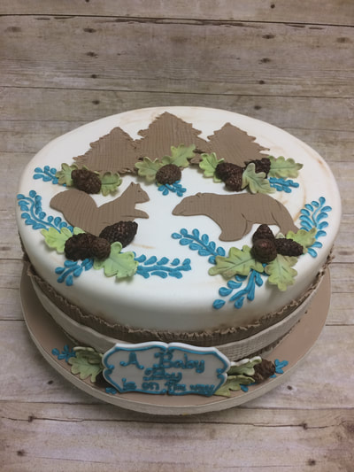 Baby sower cake with woodland animals.
