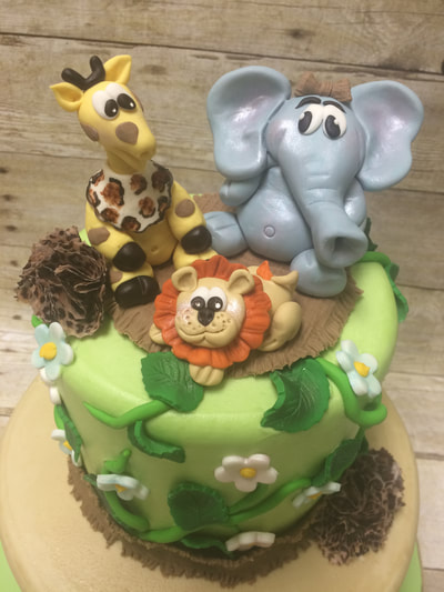 Jungle theme baby shower cake with fondant jungle animals.
