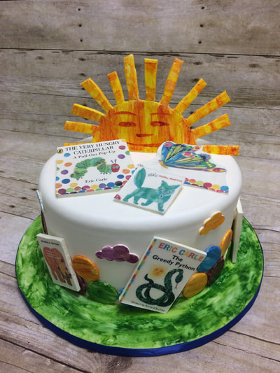 baby shower cake with sun and images from children's book.