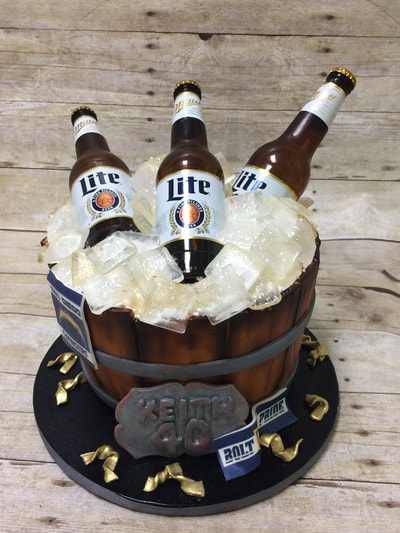Beer birthday cake in the shape of a cut in half barrel filled with ice and beer bottles. happy birthday cake.