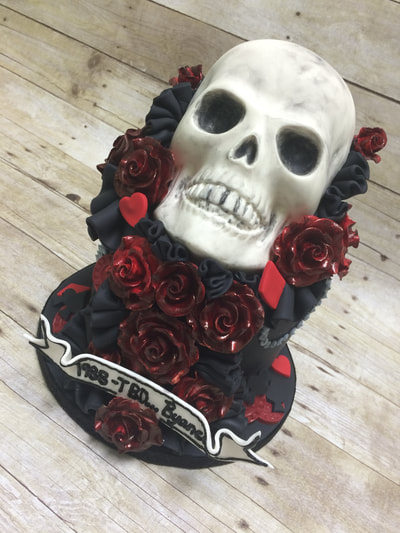 Skull cake with red and black flowers