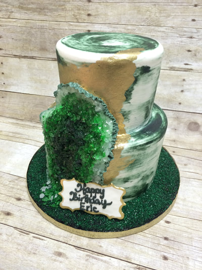 white and green naked cake with a partial geode.
