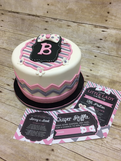 single tier fondant baby shower cake in white, pink, grey colors. all matching party invitations.